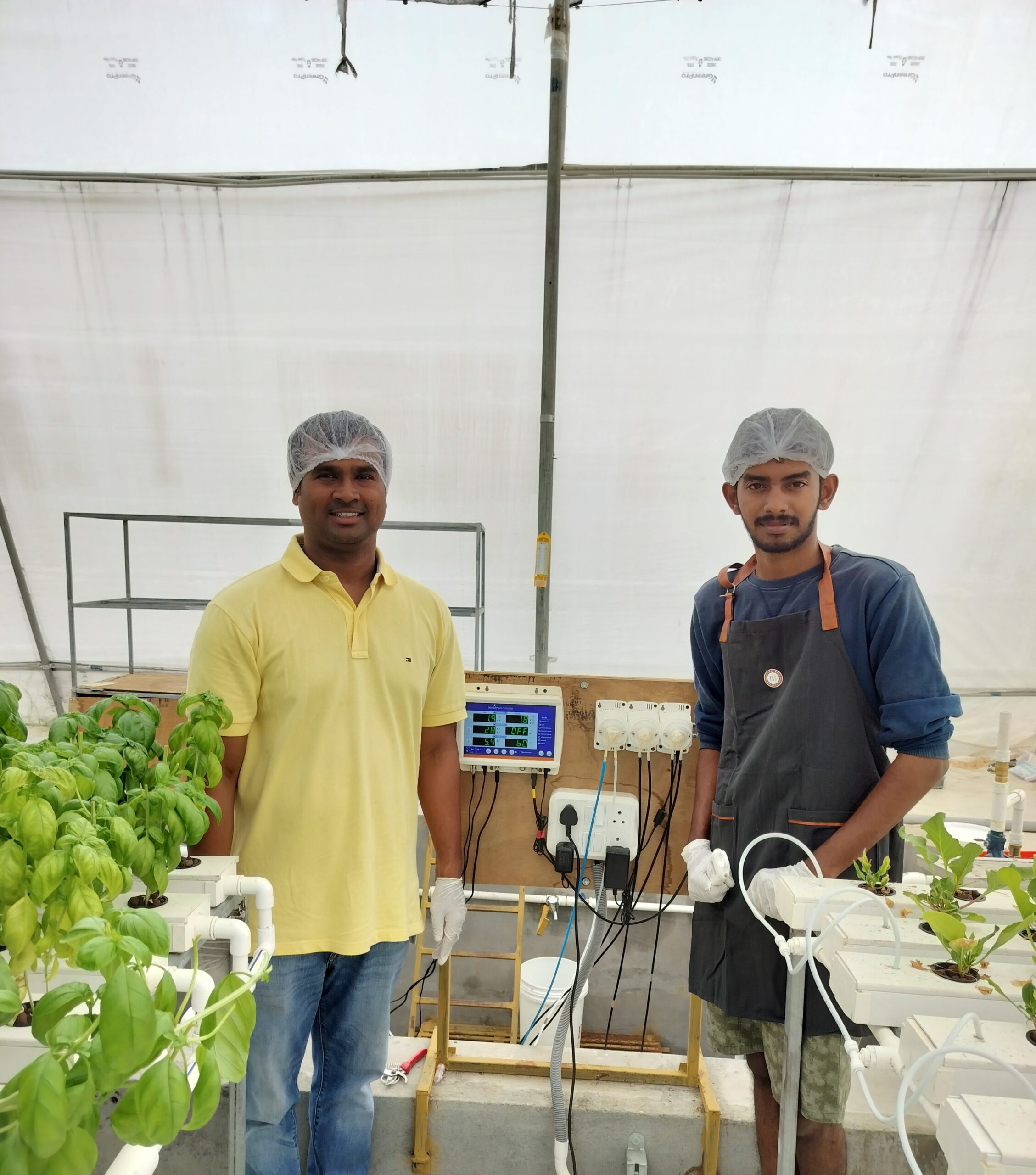The Pristine Farms team beside the climate controller